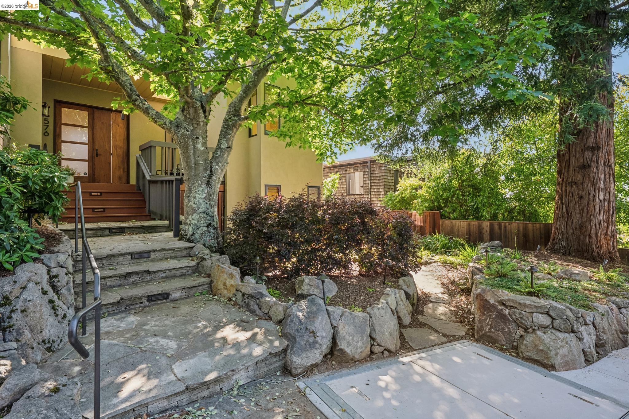 576 Vistamont Avenue Berkeley, CA 94708 - Photo 3 of 33 Stone staircase with metal handrail leading to a wooden entry deck with double wood doors