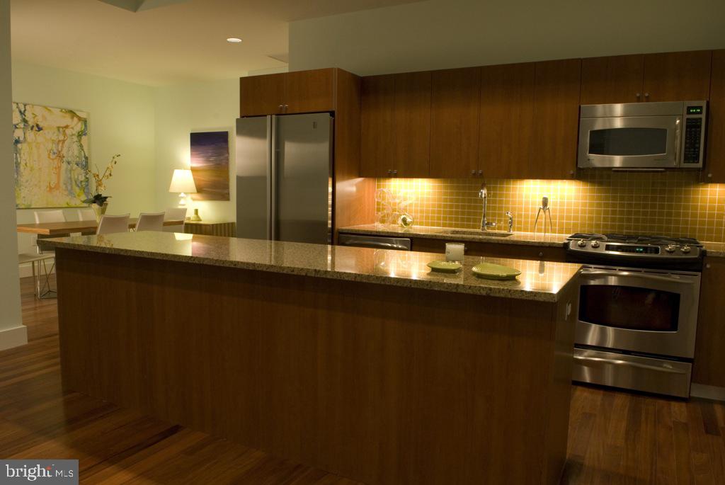 a kitchen with stainless steel appliances a sink a stove and a refrigerator