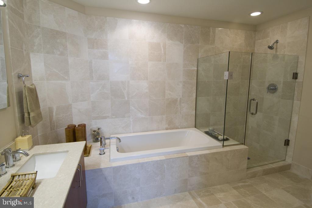 1101 Locust Street, Unit 4C Philadelphia, PA 19107 - Photo 7 of 11 a white bath tub sitting next to a white sink and a shower