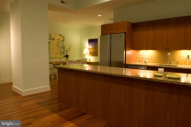 a kitchen with kitchen island a sink appliances and cabinets