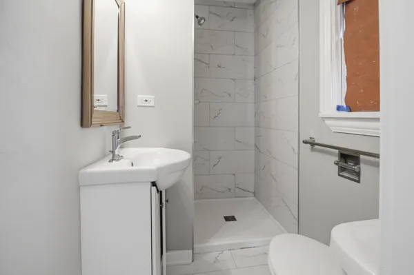 a bathroom with a sink toilet and shower