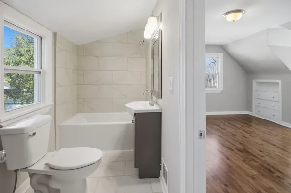 a bathroom with a toilet a sink and bathtub