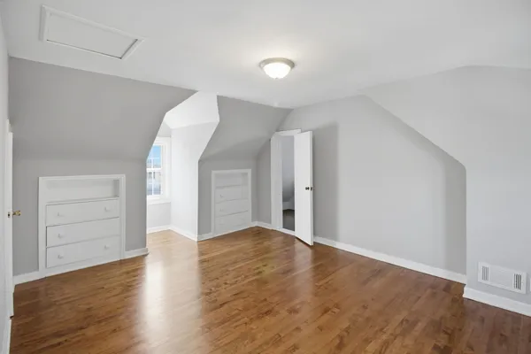 an empty room with wooden floor