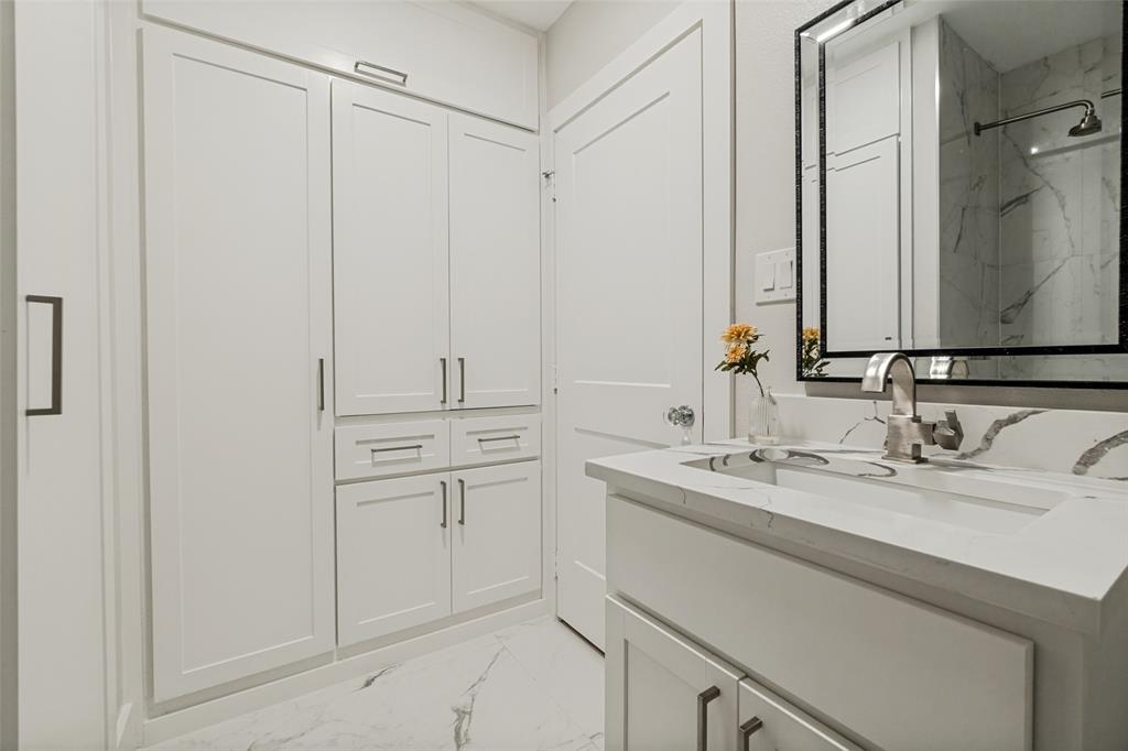 2006 Marydale Road Dallas, TX 75208 - Photo 30 of 40 Integrated vanity with an undermount sink and a polished chrome faucet, set against white cabinetry