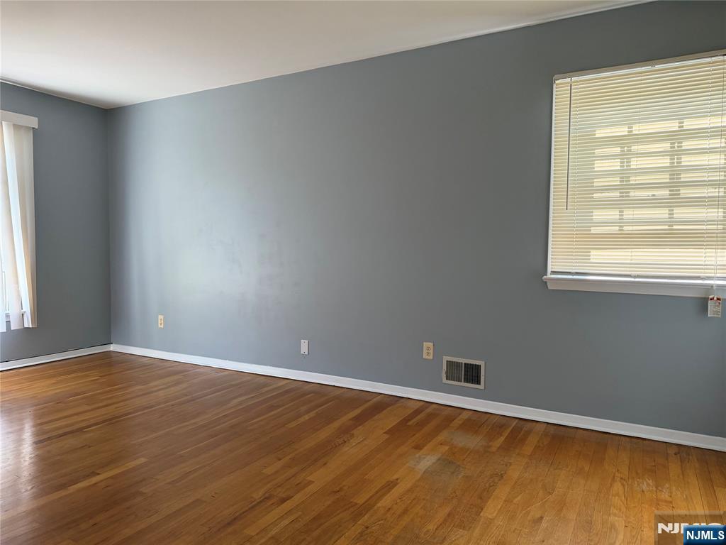 39 Franklin Street, Unit 2 Tenafly, NJ 07670 - Photo 12 of 27 an empty room with wooden floor and windows