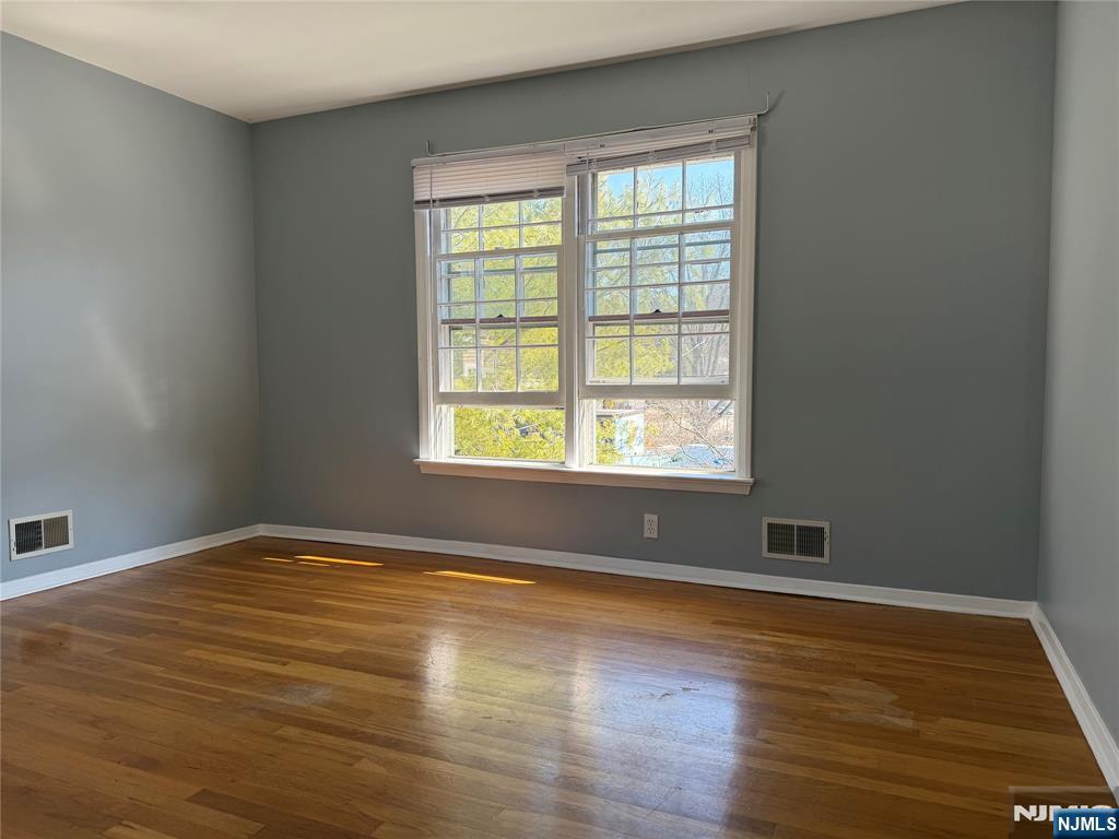 39 Franklin Street, Unit 2 Tenafly, NJ 07670 - Photo 15 of 27 an empty room with wooden floor and windows