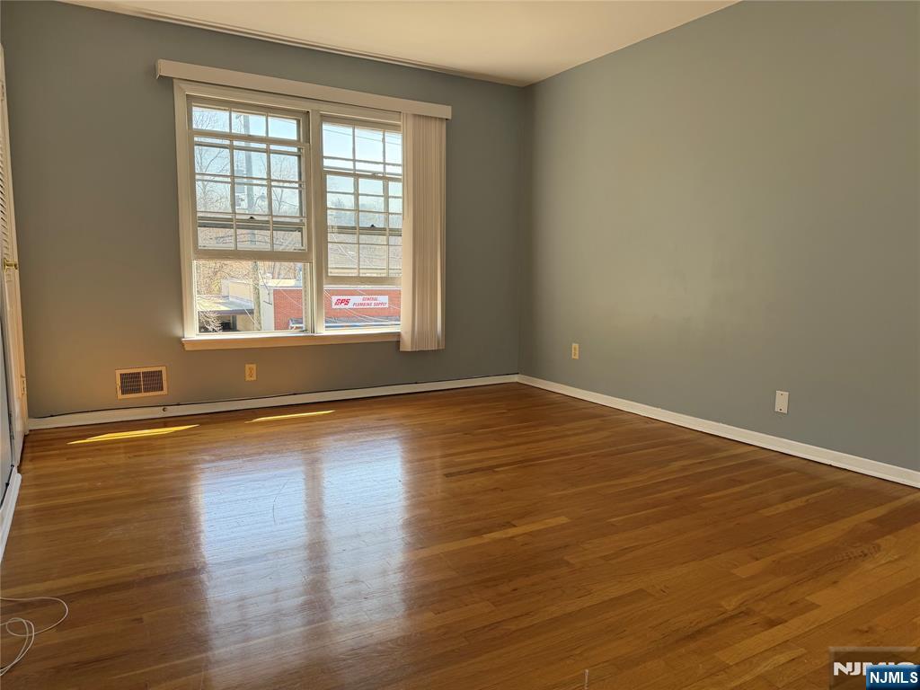 39 Franklin Street, Unit 2 Tenafly, NJ 07670 - Photo 24 of 27 a view of an empty room with wooden floor and a window
