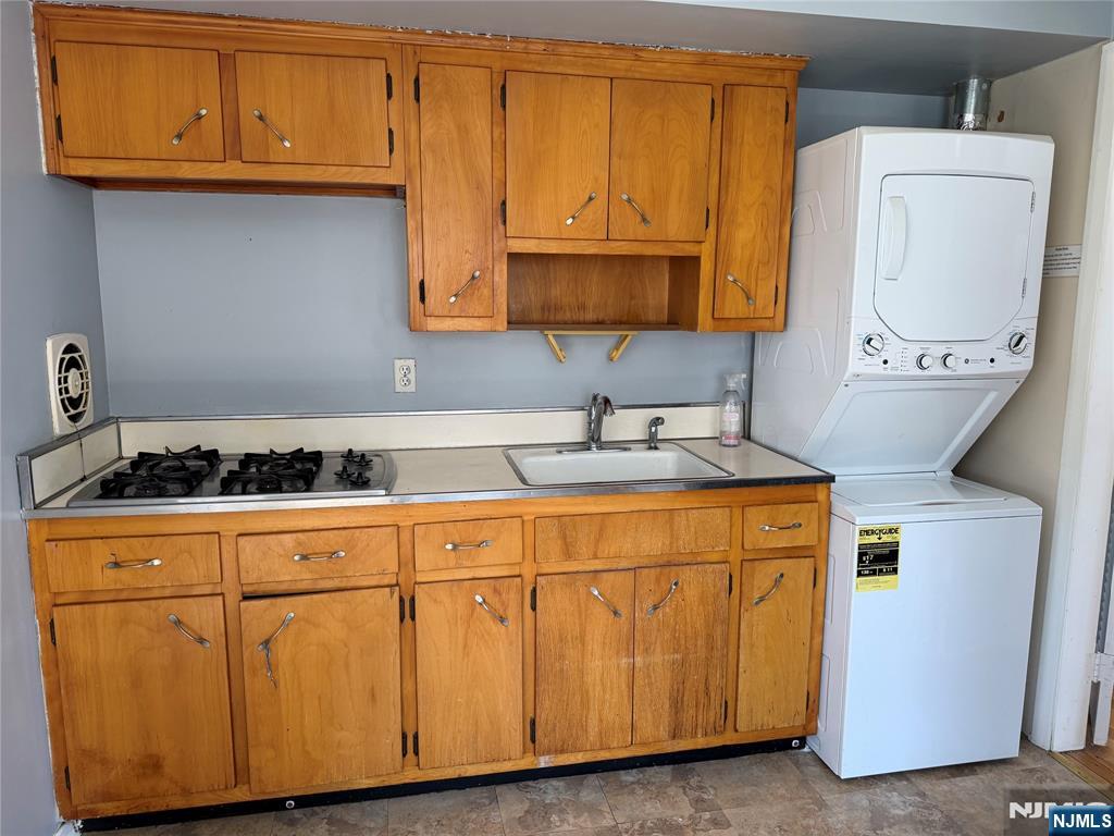39 Franklin Street, Unit 2 Tenafly, NJ 07670 - Photo 5 of 27 a bathroom with a granite countertop sink and washing machine