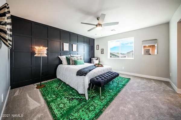 a bedroom with a bed and a chandelier