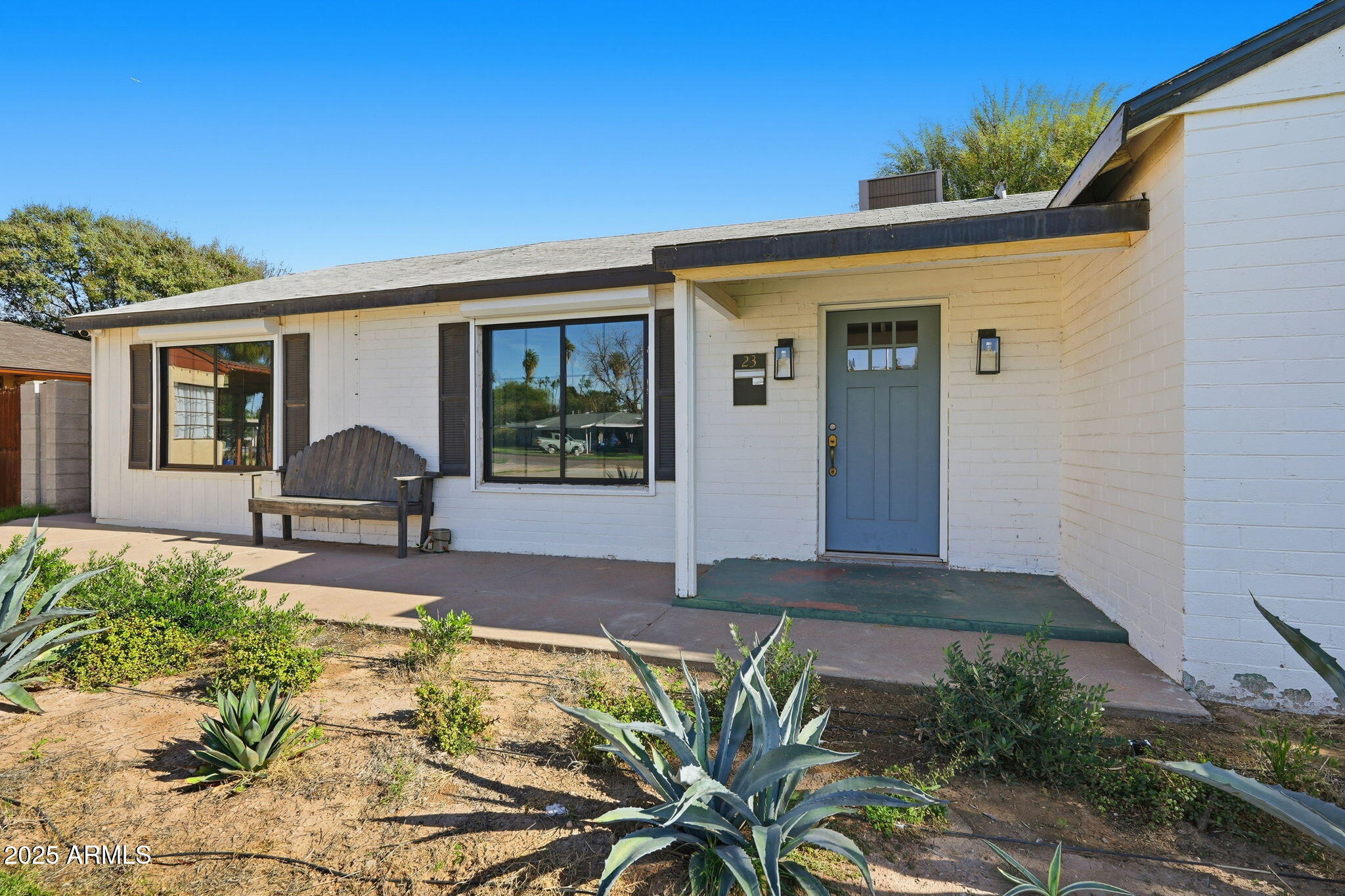 23 North Edgemont Mesa, AZ 85203 - Photo 2 of 25 a front view of a house with a yard and potted plants