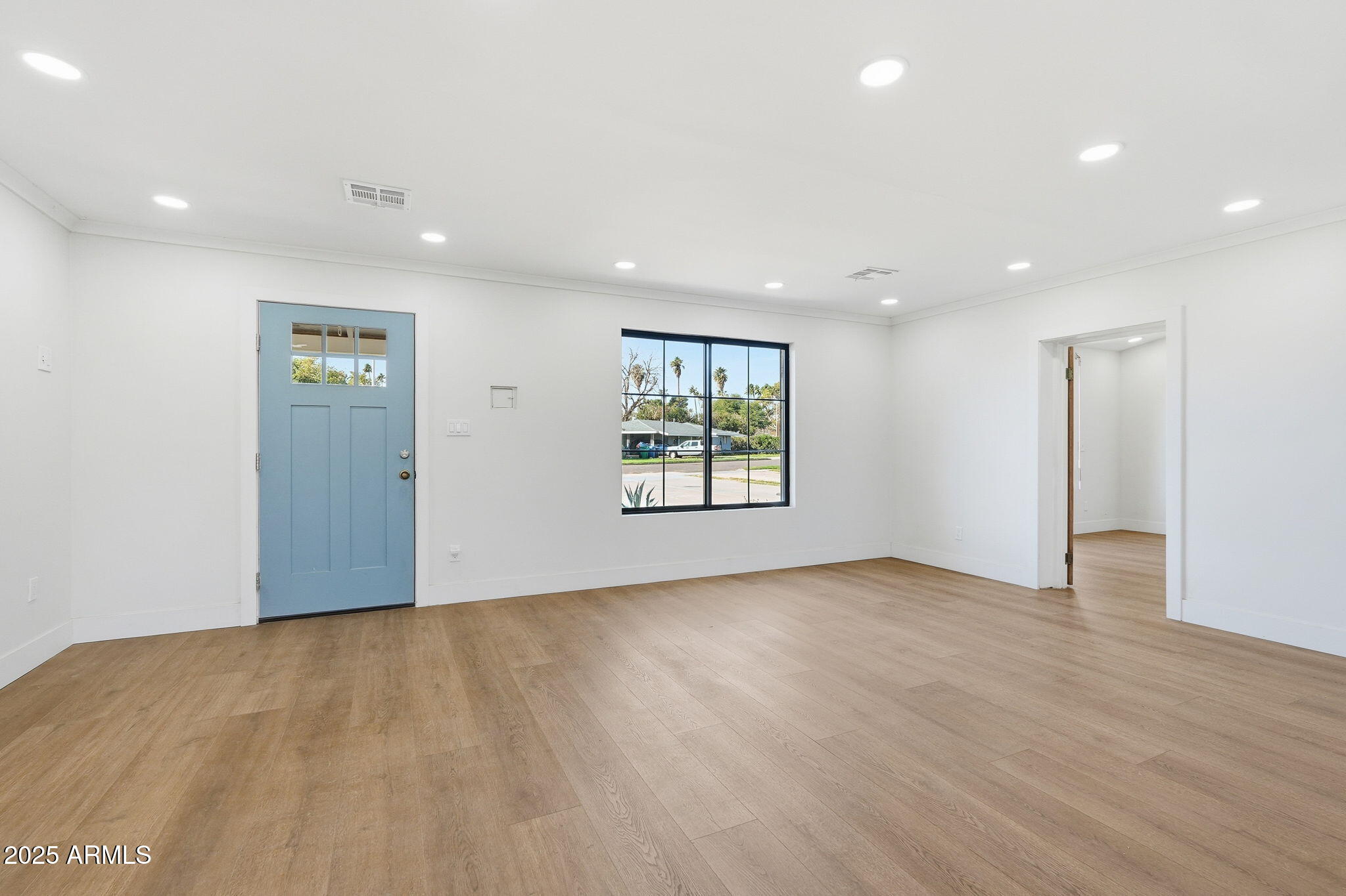 23 North Edgemont Mesa, AZ 85203 - Photo 9 of 25 an empty room with wooden floor and windows