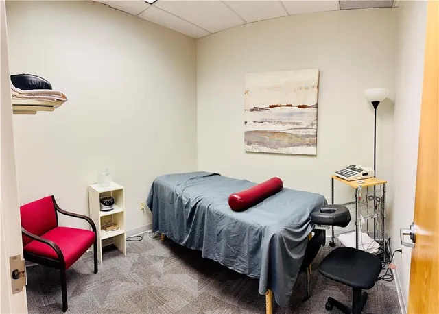 a bedroom with a bed and a chair