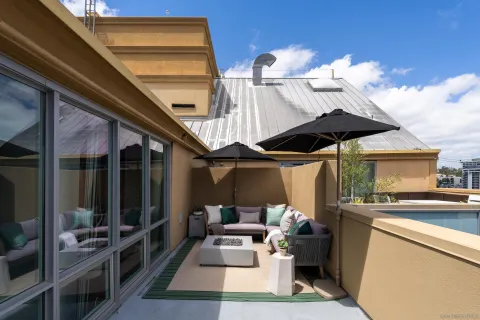 a view of a chairs and table in the balcony
