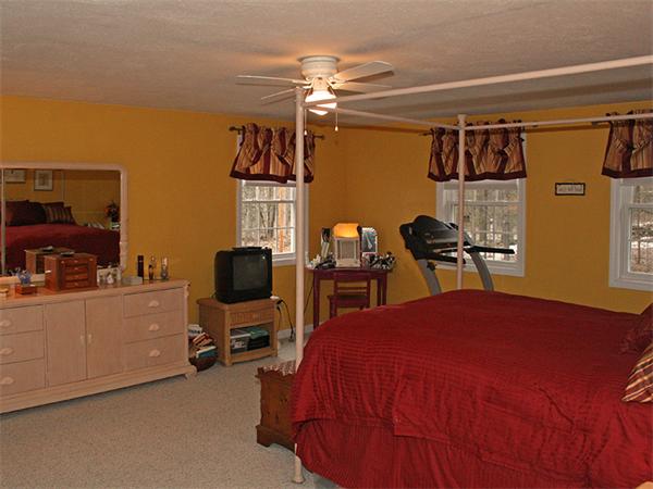 65 Young Road Ashburnham, MA 01430 - Photo 11 of 22 a bedroom with a bed and a tv on the dresser