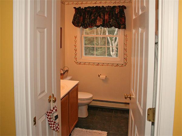 65 Young Road Ashburnham, MA 01430 - Photo 13 of 22 a bathroom with a toilet a sink a window and shower