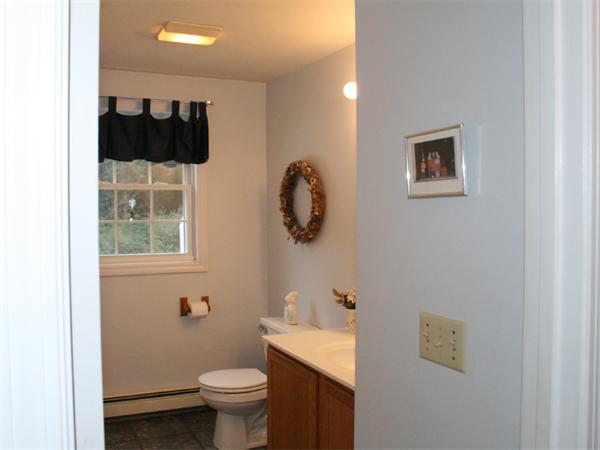 65 Young Road Ashburnham, MA 01430 - Photo 17 of 22 a bathroom with a toilet a sink and mirror