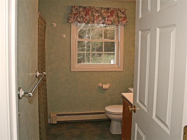 65 Young Road Ashburnham, MA 01430 - Photo 18 of 22 a bathroom with a granite countertop toilet a sink and a shower