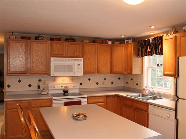 65 Young Road Ashburnham, MA 01430 - Photo 3 of 22 a kitchen with stainless steel appliances granite countertop a sink dishwasher and a stove with wooden floor