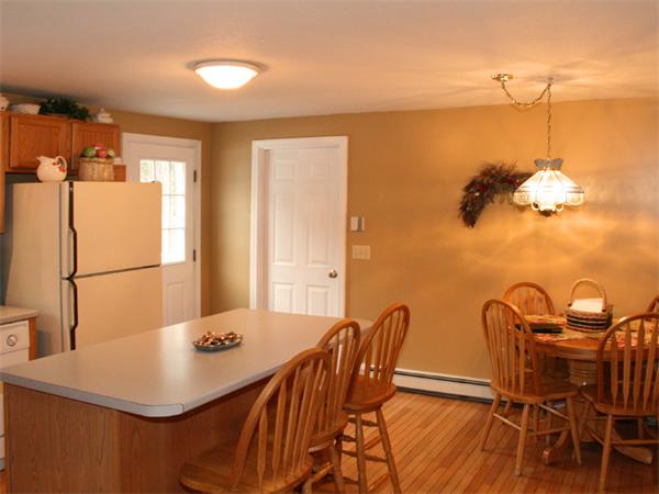 65 Young Road Ashburnham, MA 01430 - Photo 4 of 22 a view of a dining room with furniture and a chandelier