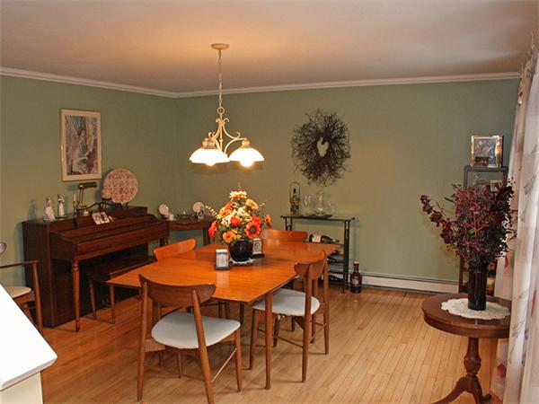 65 Young Road Ashburnham, MA 01430 - Photo 6 of 22 a view of a dining room with furniture wooden floor and a chandelier