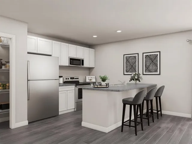 a kitchen with refrigerator cabinets and wooden floor