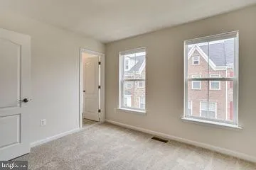 an empty room with windows and closet