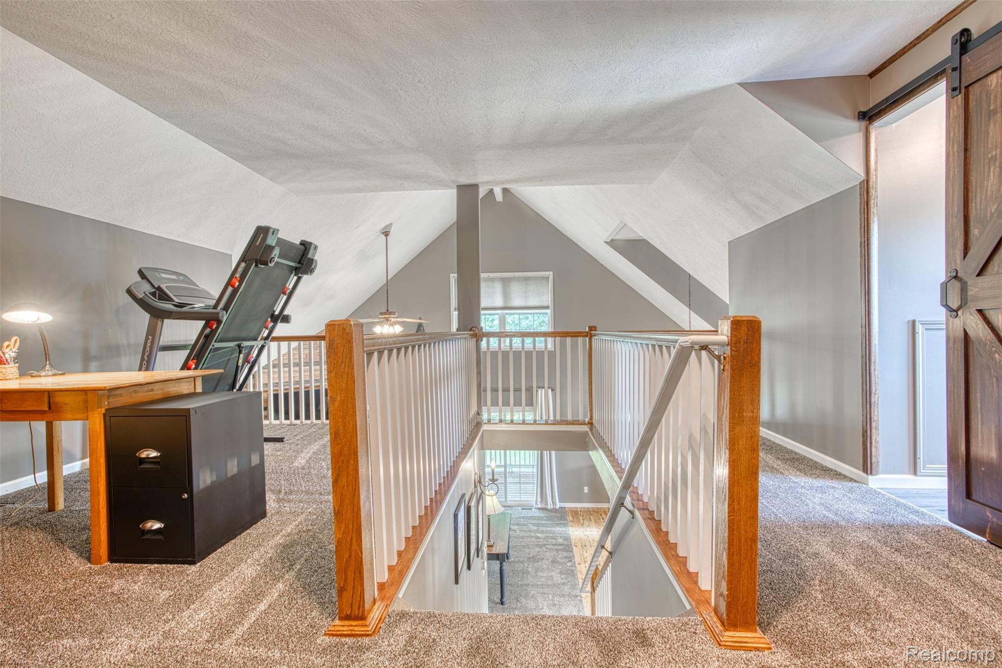 7016 West Lange Road Fowlerville, MI 48836 - Photo 27 of 61 THE STAIRS UP TO THE LOFT AREA FROM THE GREAT ROOM