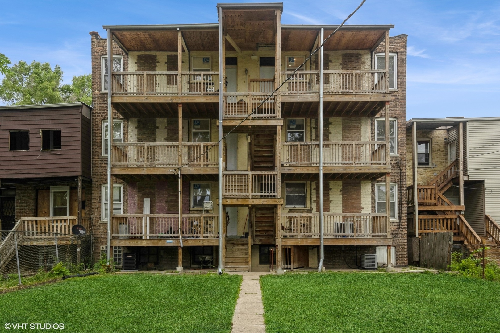 5027-29 West Washington Boulevard Chicago, IL 60644 - Photo 23 of 33 a large building with a small yard and more windows
