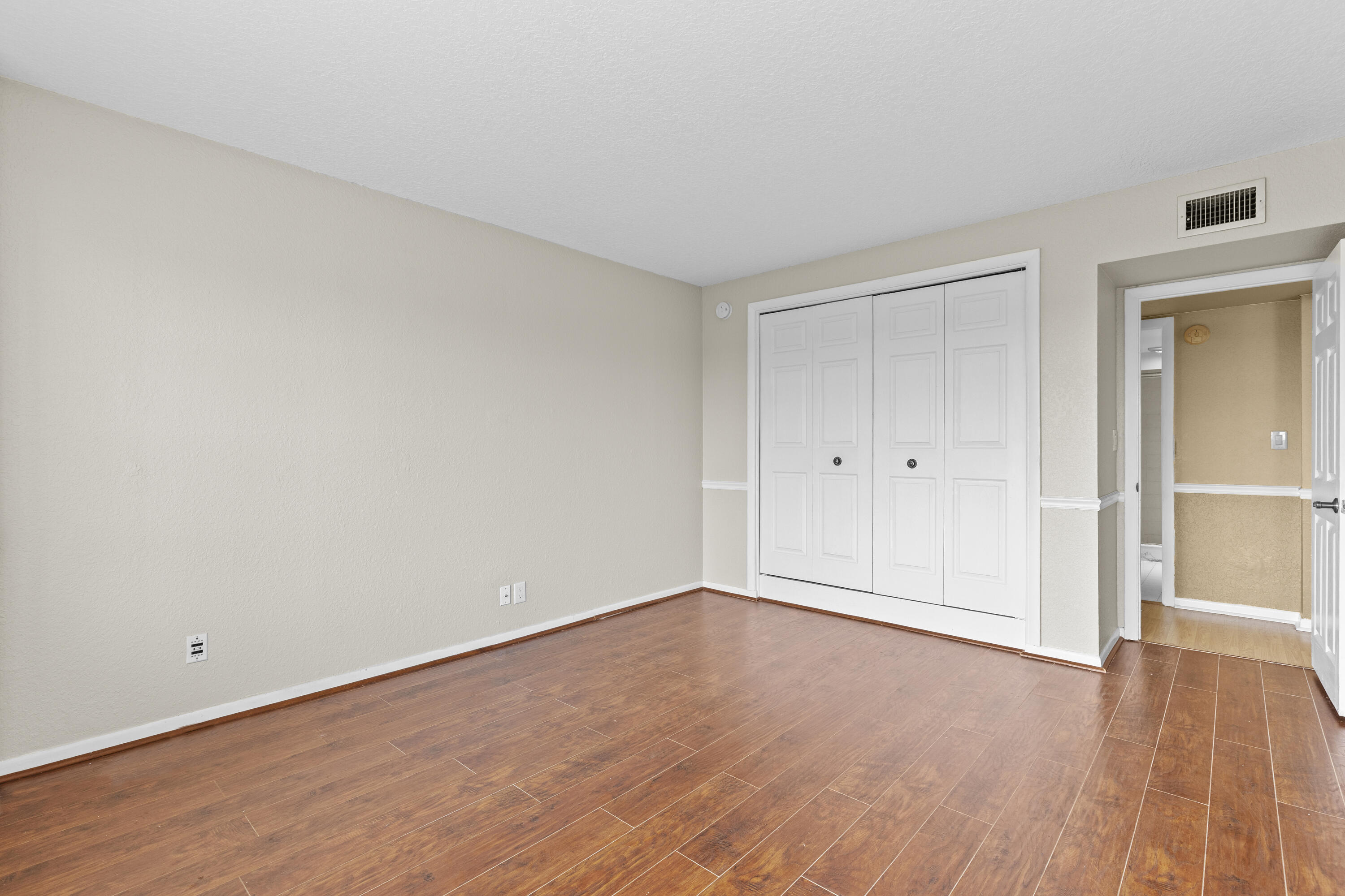 10777 West Sample Road, Unit 719 Coral Springs, FL 33065 - Photo 17 of 44 a view of an empty room and wooden floor