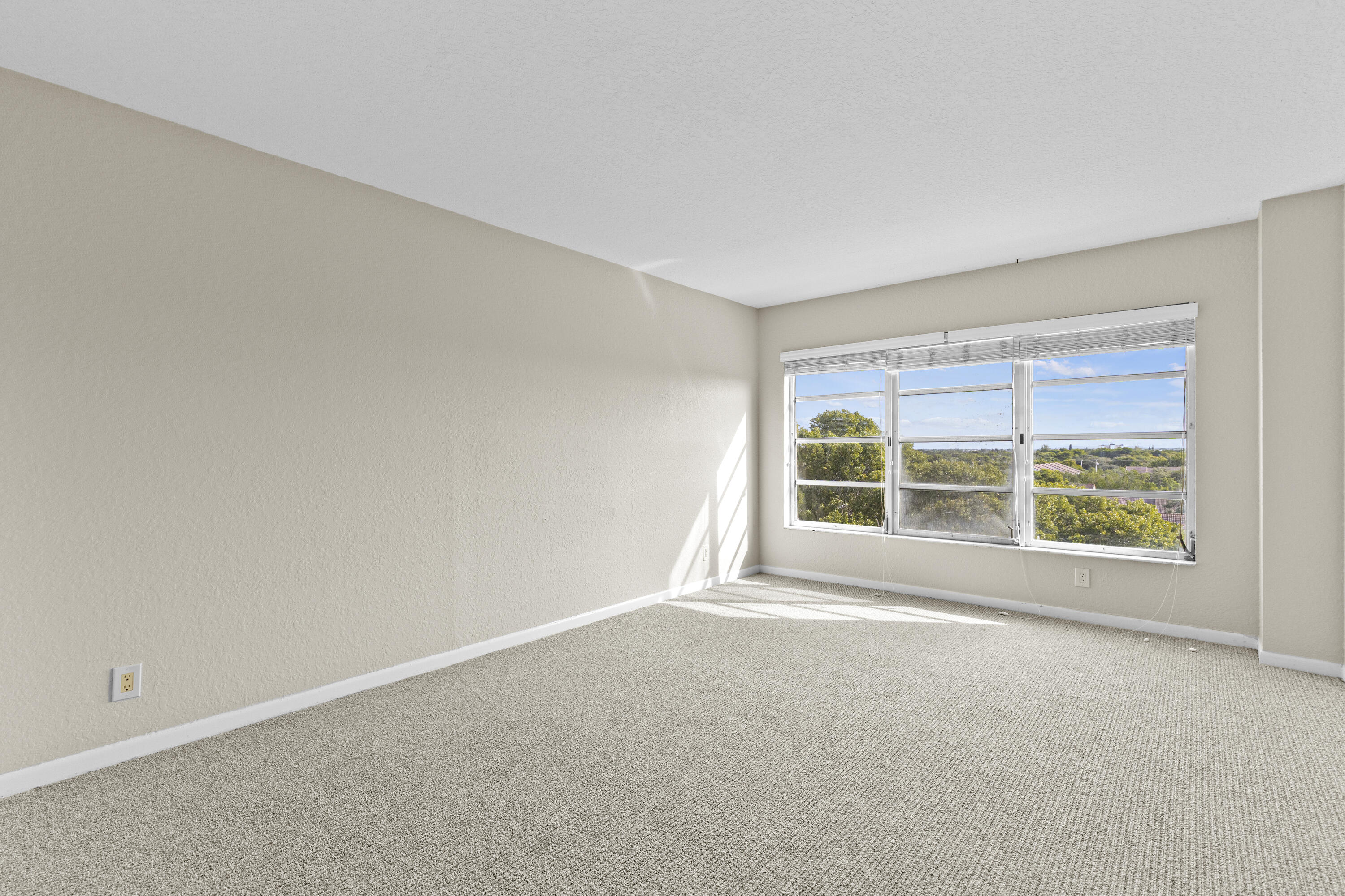 10777 West Sample Road, Unit 719 Coral Springs, FL 33065 - Photo 19 of 44 an empty room with a window