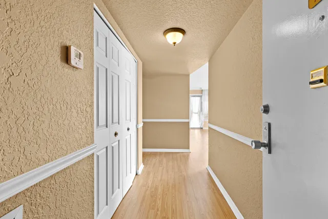 a view of a hallway with wooden floor