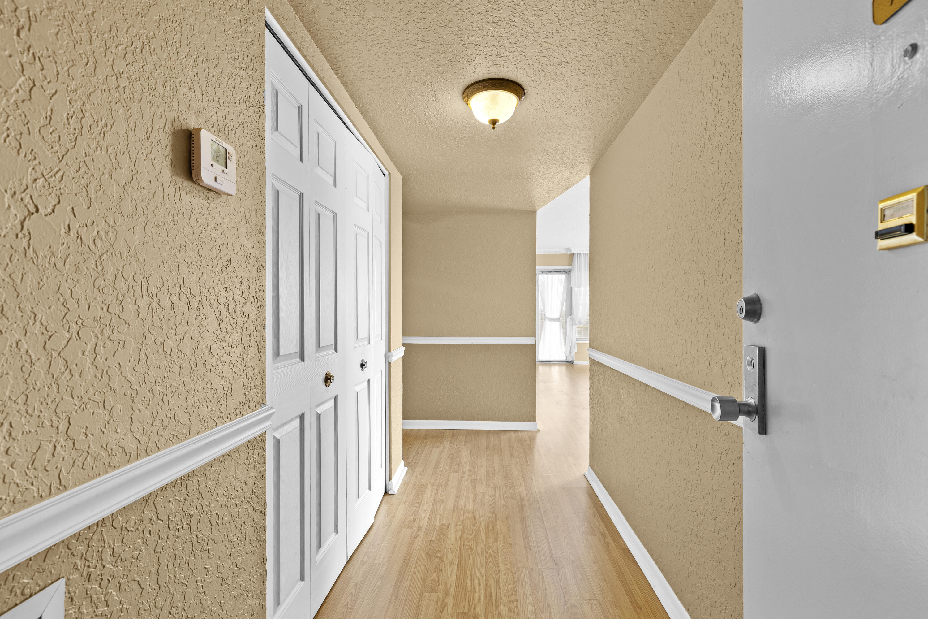 10777 West Sample Road, Unit 719 Coral Springs, FL 33065 - Photo 2 of 44 a view of a hallway with wooden floor and staircase