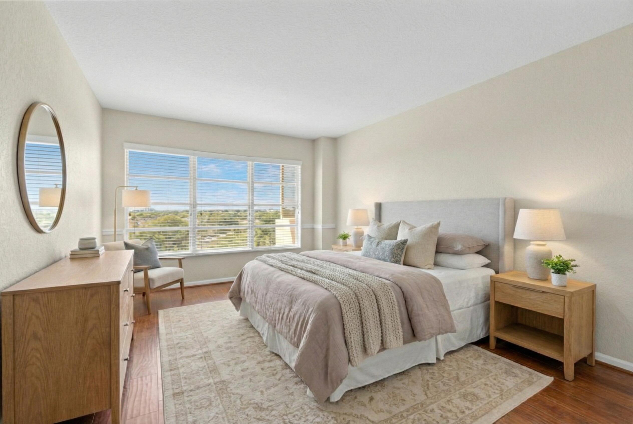 10777 West Sample Road, Unit 719 Coral Springs, FL 33065 - Photo 23 of 44 a bed room with a bed a mirror and a large window