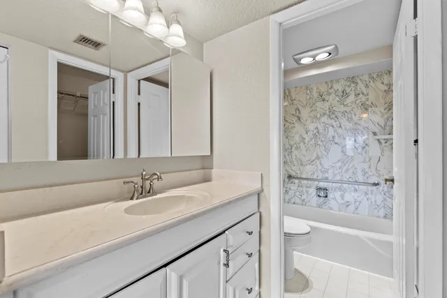 a bathroom with a toilet and a tub