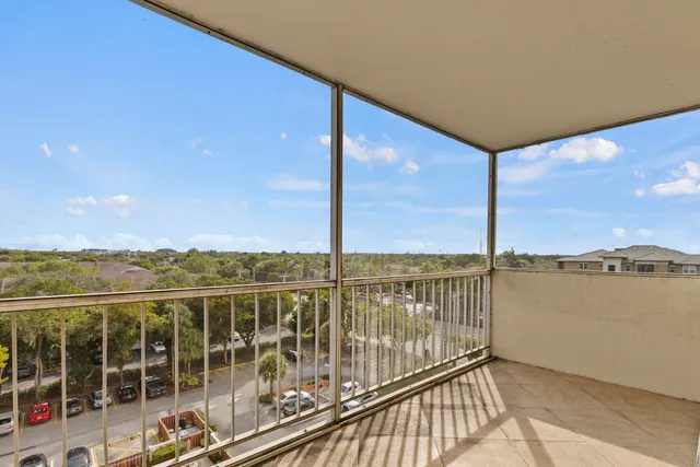 a view of balcony with floor to ceiling windows with wooden floor