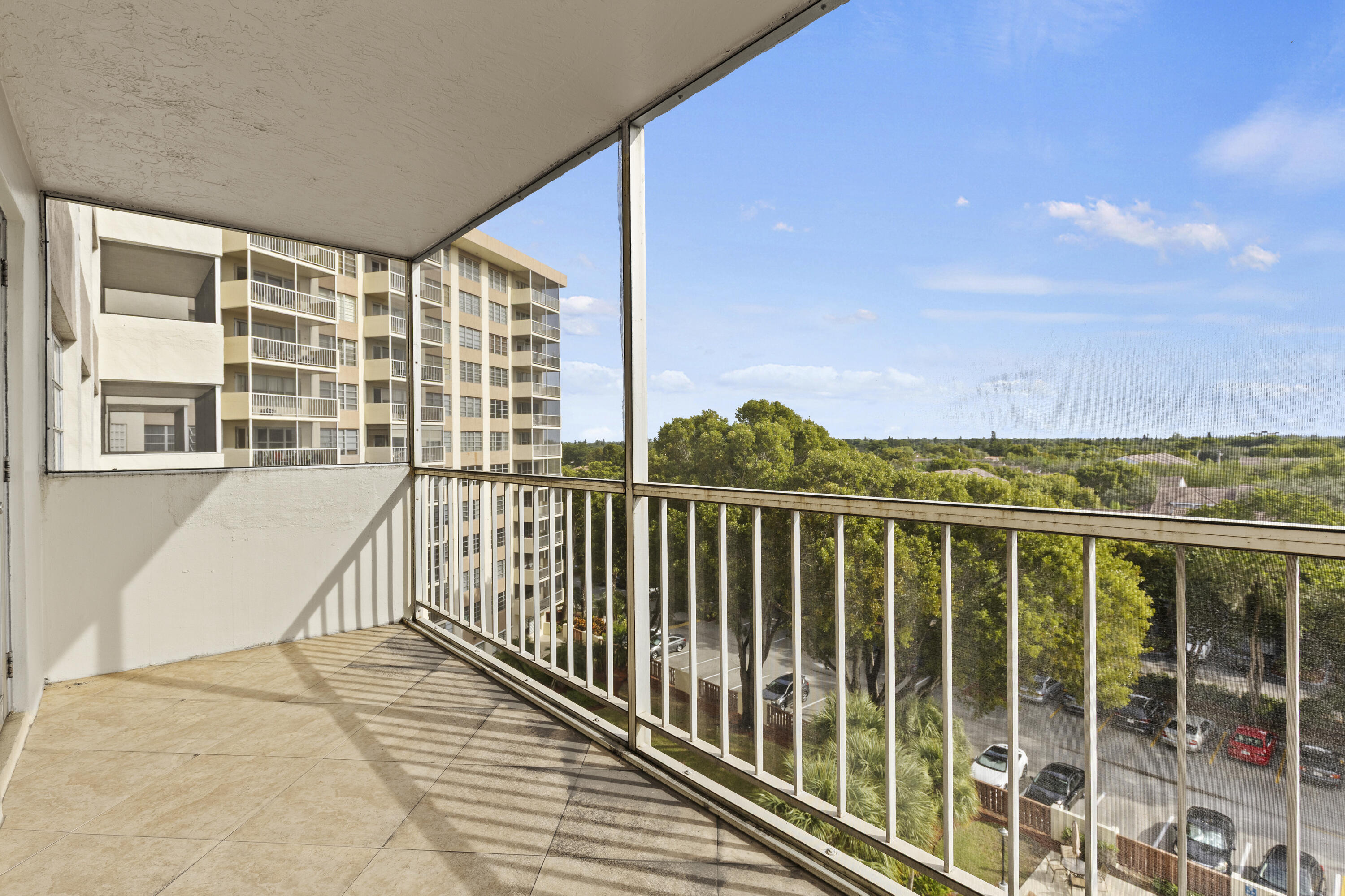 10777 West Sample Road, Unit 719 Coral Springs, FL 33065 - Photo 28 of 44 a view of balcony with floor to ceiling windows with wooden floor