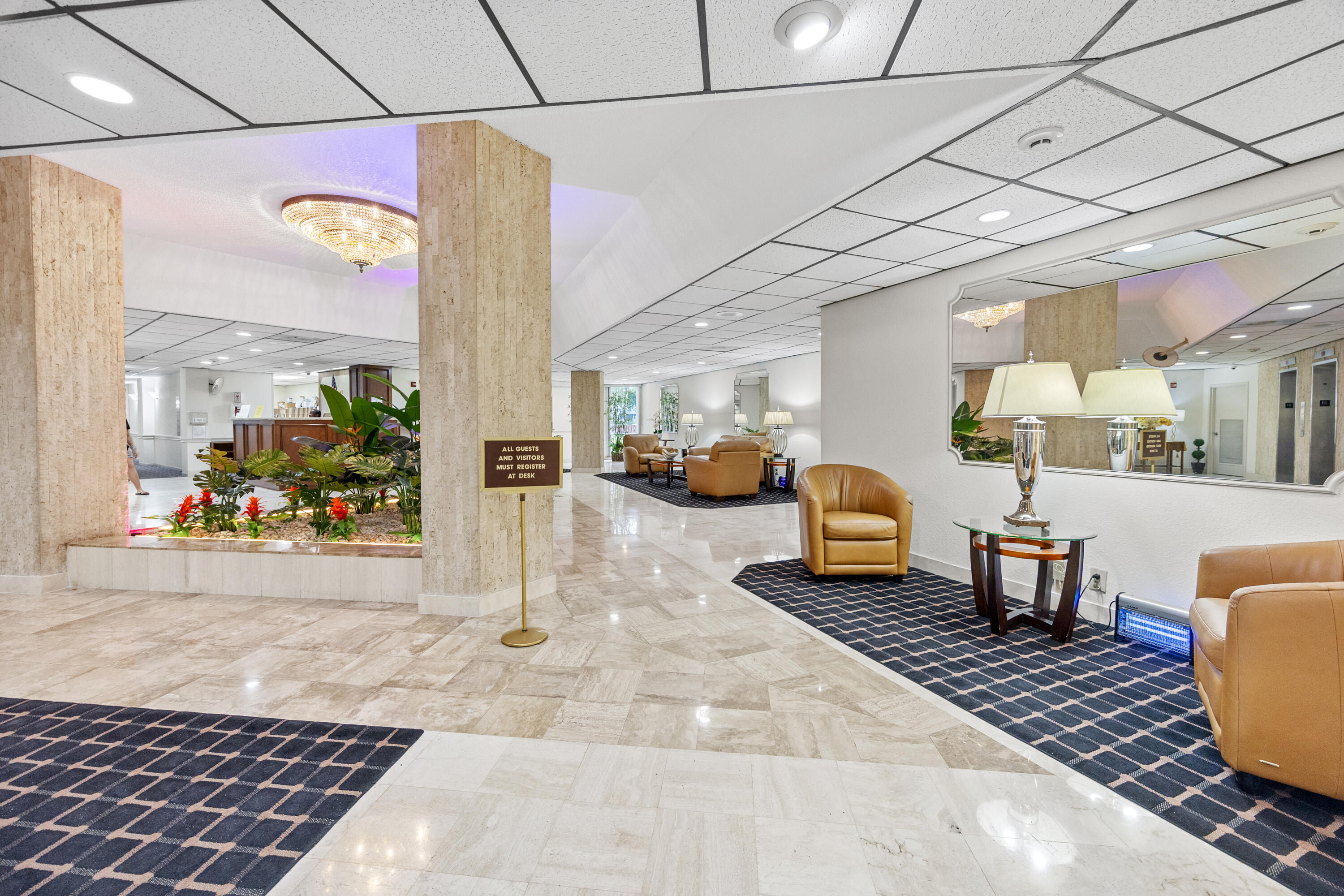 10777 West Sample Road, Unit 719 Coral Springs, FL 33065 - Photo 30 of 44 a lobby with furniture and a potted plant