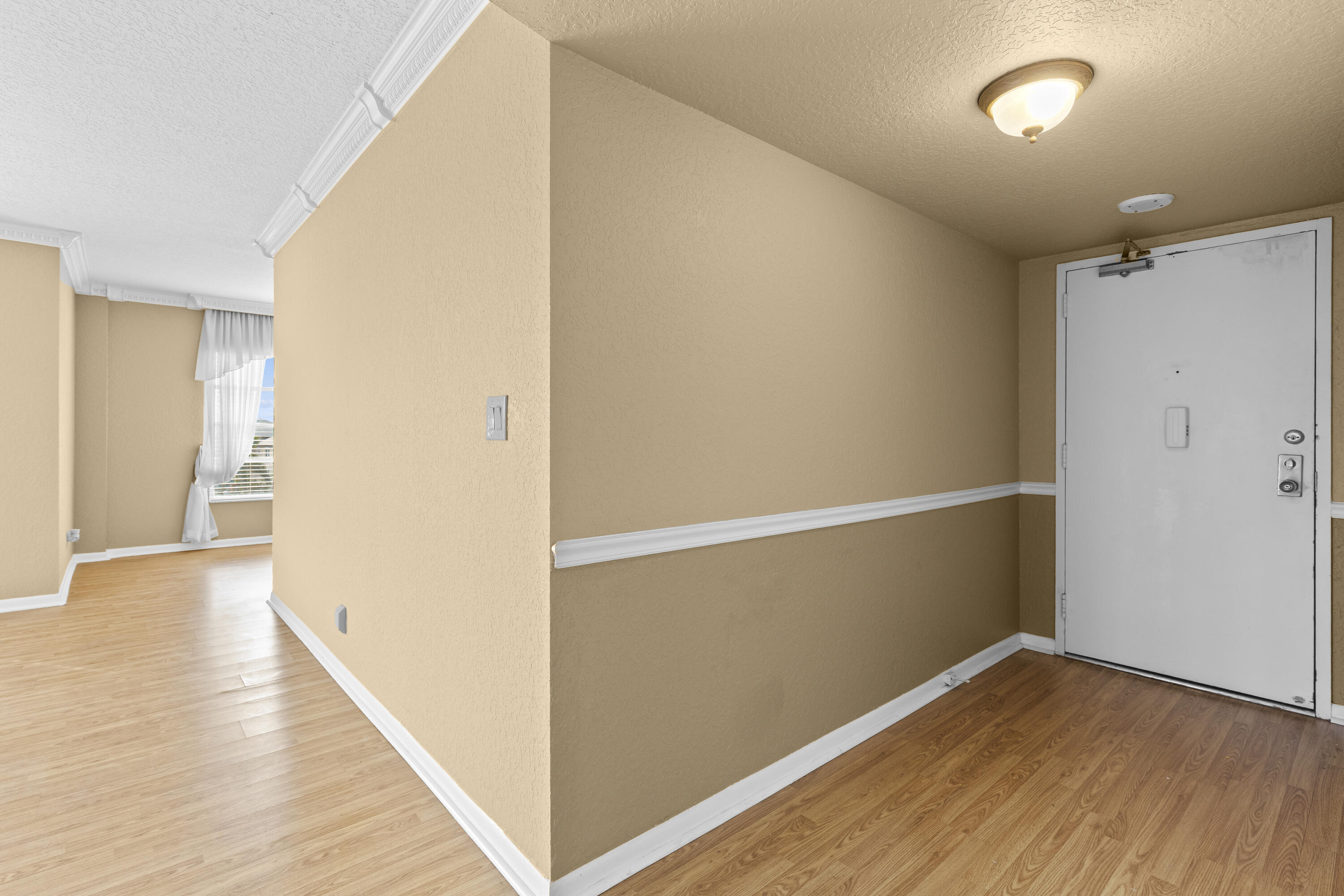 10777 West Sample Road, Unit 719 Coral Springs, FL 33065 - Photo 4 of 44 a view of hallway with wooden floor