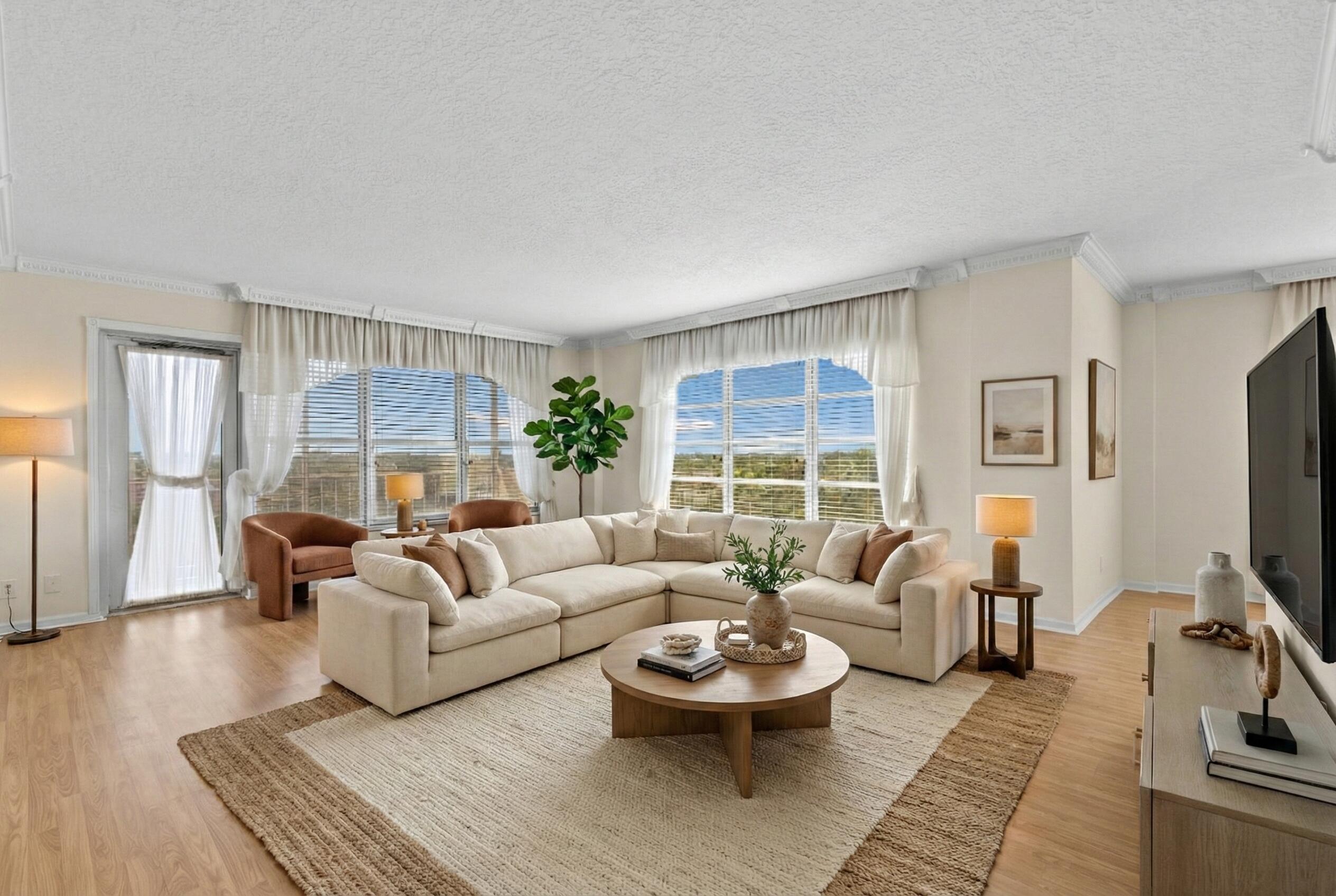 10777 West Sample Road, Unit 719 Coral Springs, FL 33065 - Photo 6 of 44 a living room with furniture and a flat screen tv