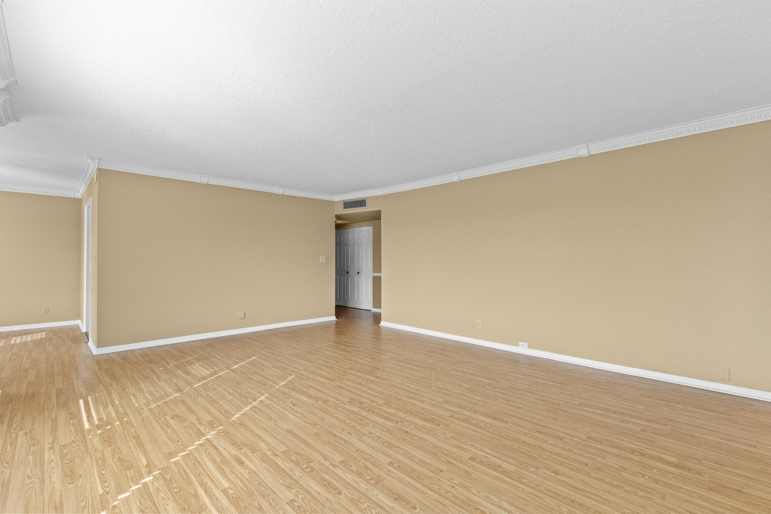 10777 West Sample Road, Unit 719 Coral Springs, FL 33065 - Photo 9 of 44 a view of an empty room with wooden floor