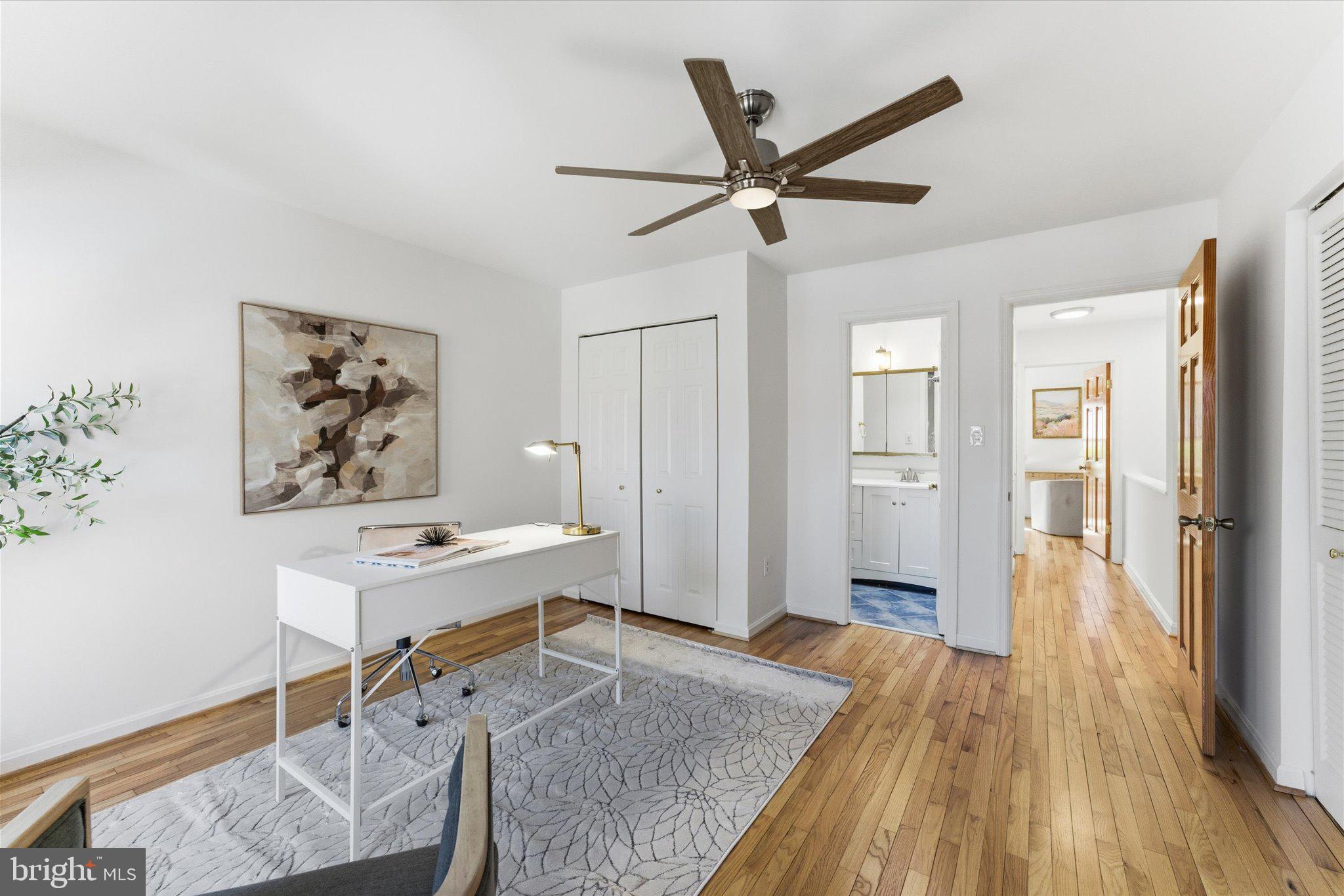 1645 Park Road Northwest Washington, DC 20010 - Photo 18 of 28 a workspace with wooden floor and a chandelier fan