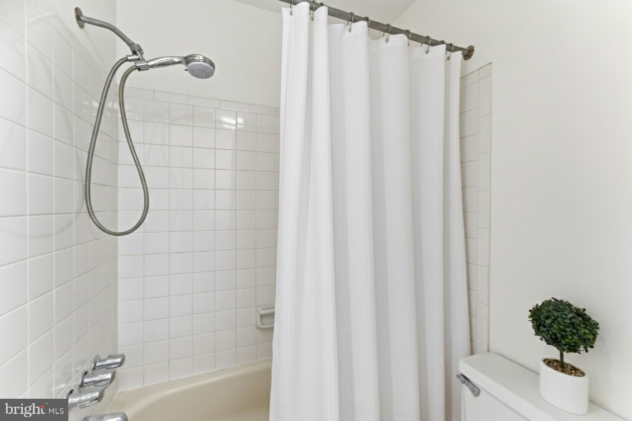 1645 Park Road Northwest Washington, DC 20010 - Photo 21 of 28 a bathroom with a shower curtain and a shower curtain