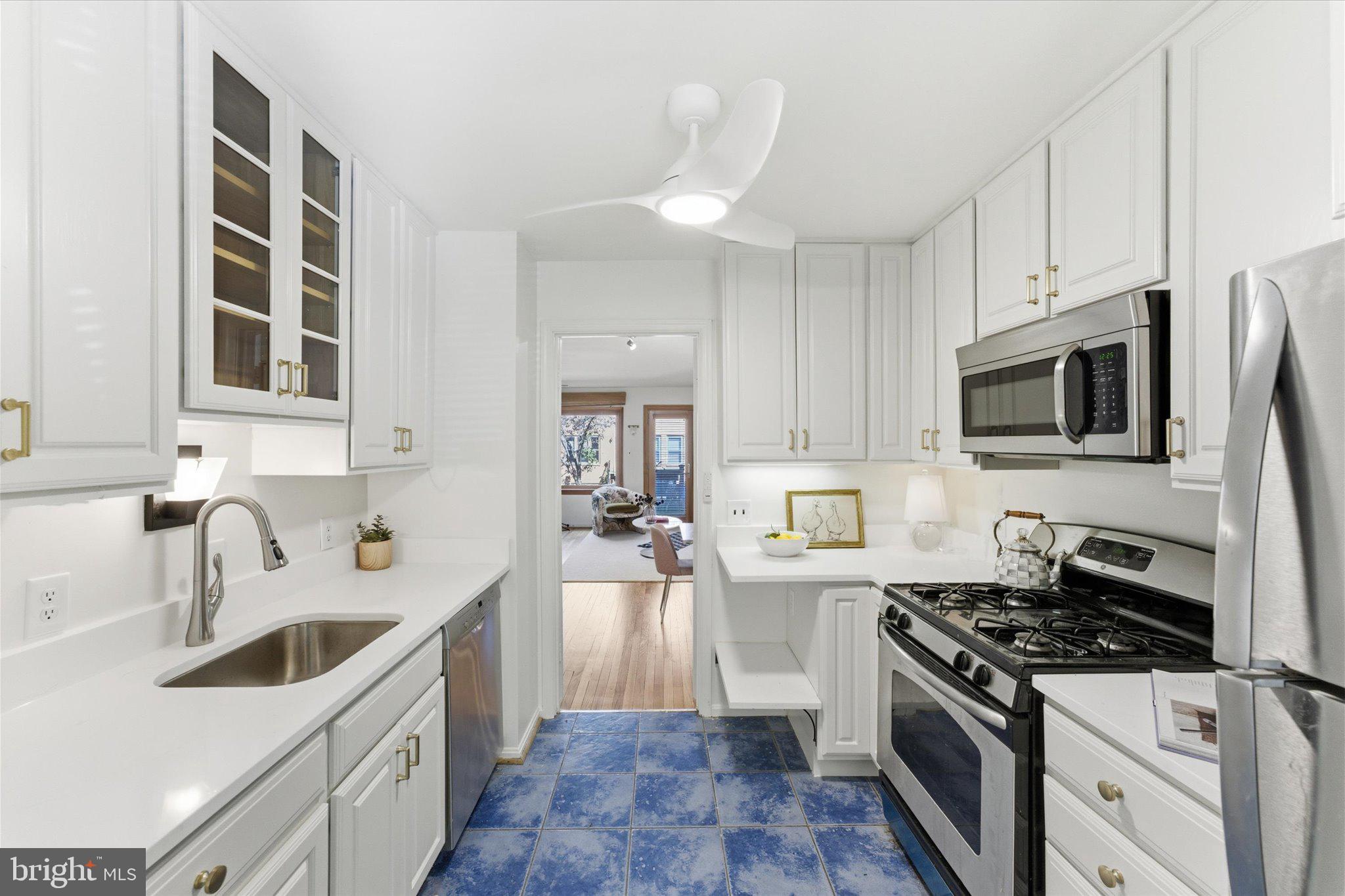 1645 Park Road Northwest Washington, DC 20010 - Photo 4 of 28 a kitchen with stainless steel appliances a sink a stove top oven a counter space and cabinets