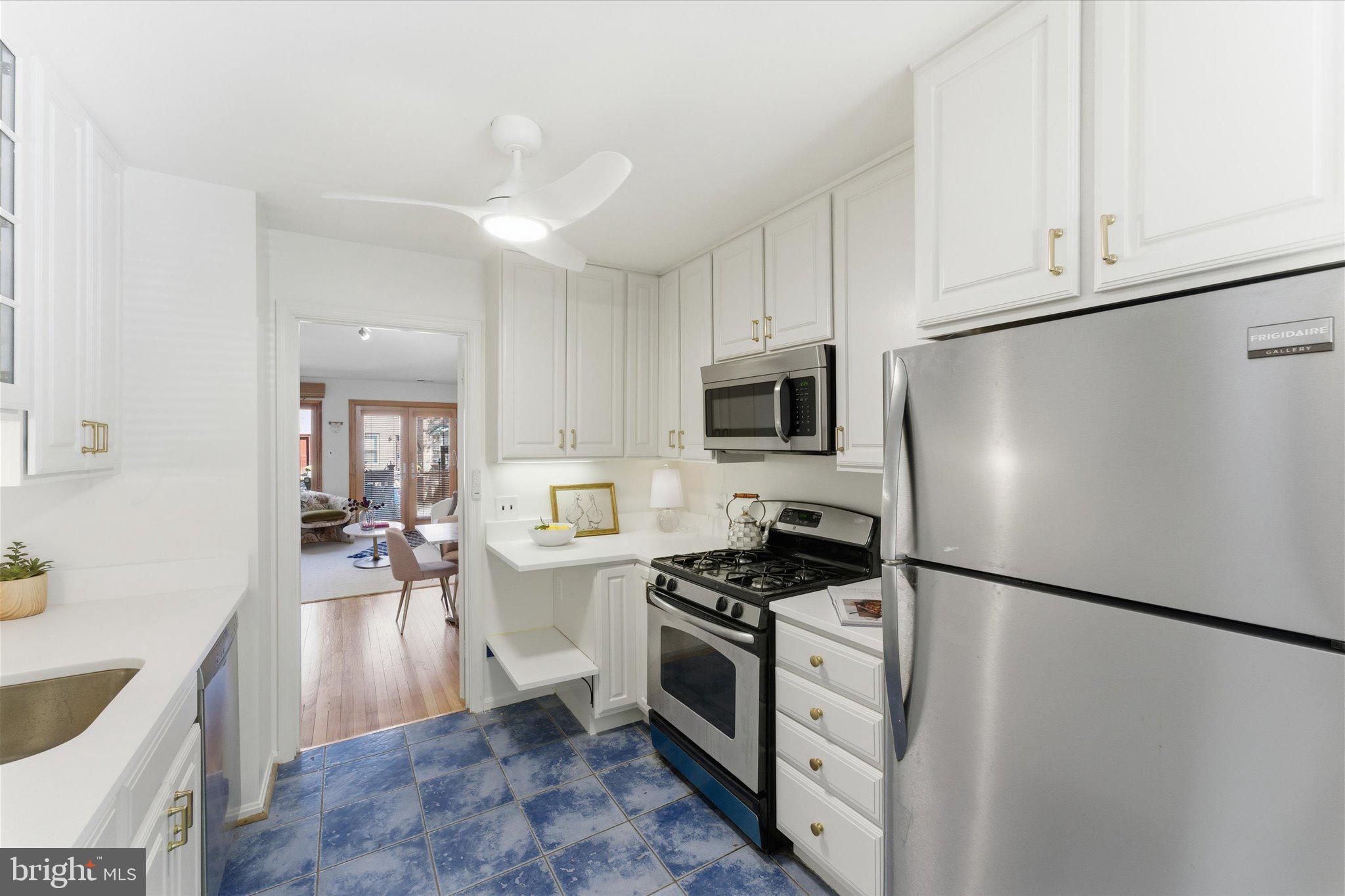 1645 Park Road Northwest Washington, DC 20010 - Photo 5 of 28 a kitchen with white cabinets and stainless steel appliances