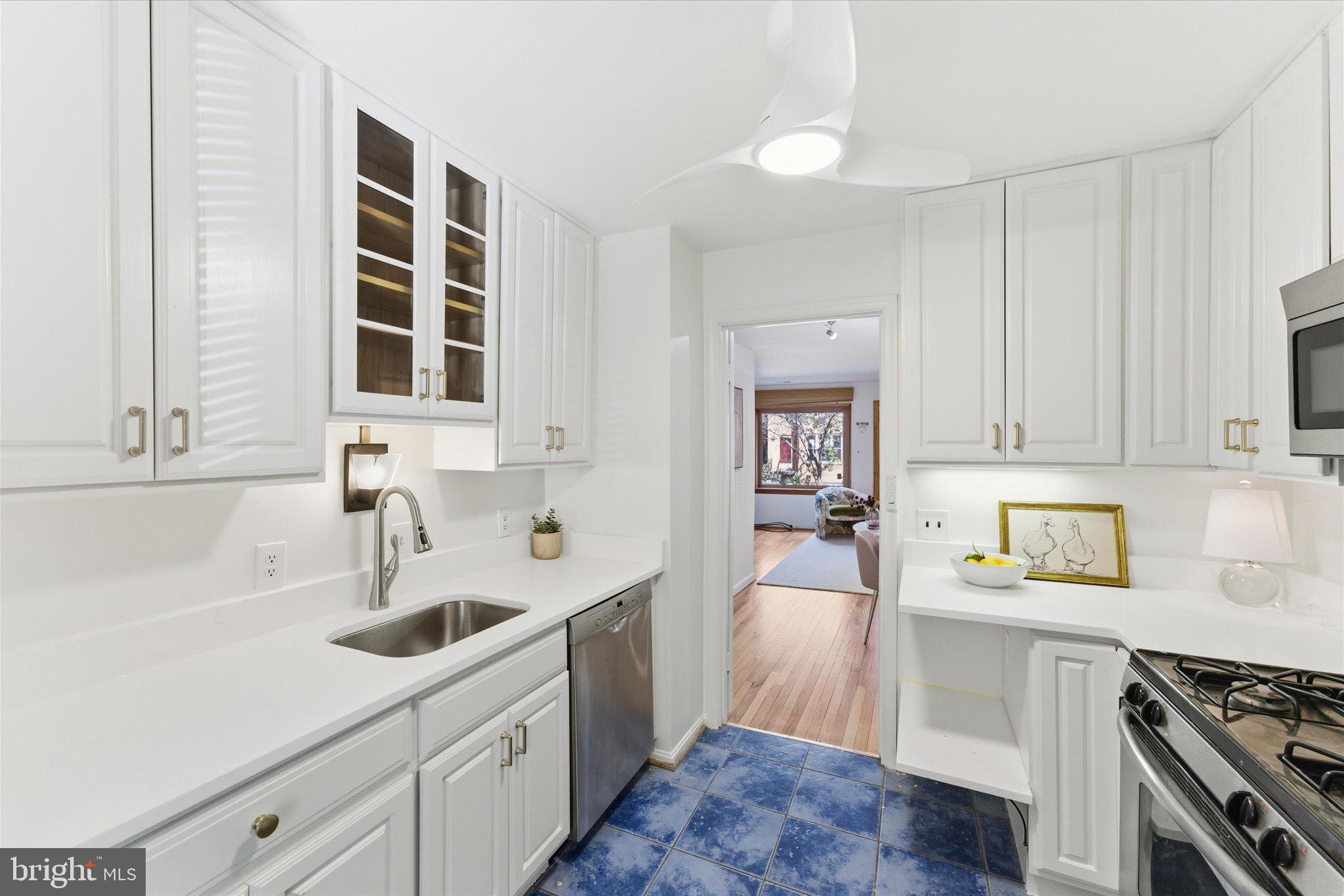 1645 Park Road Northwest Washington, DC 20010 - Photo 6 of 28 a kitchen with a sink stove and cabinets