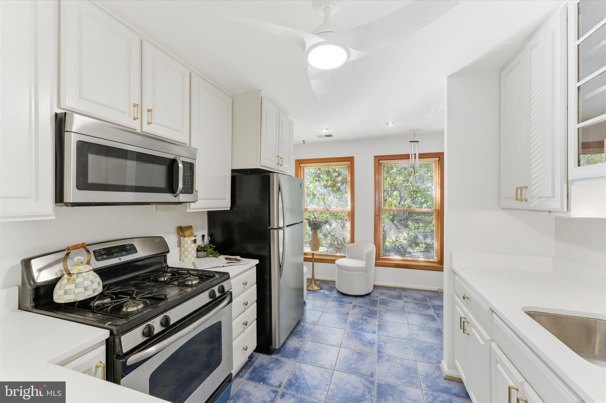 1645 Park Road Northwest Washington, DC 20010 - Photo 7 of 28 a kitchen with stainless steel appliances a stove a sink and a microwave