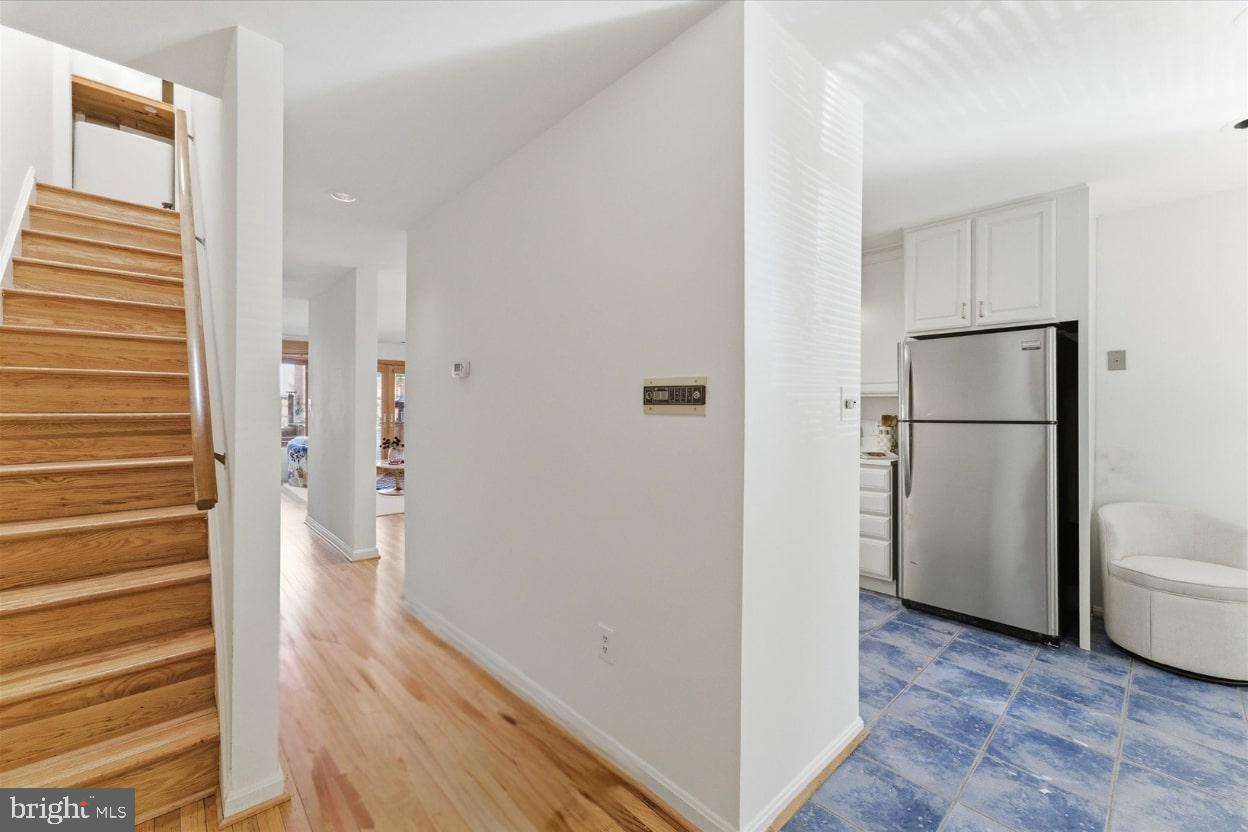 1645 Park Road Northwest Washington, DC 20010 - Photo 9 of 28 a view of a hallway with wooden floor and cabinets