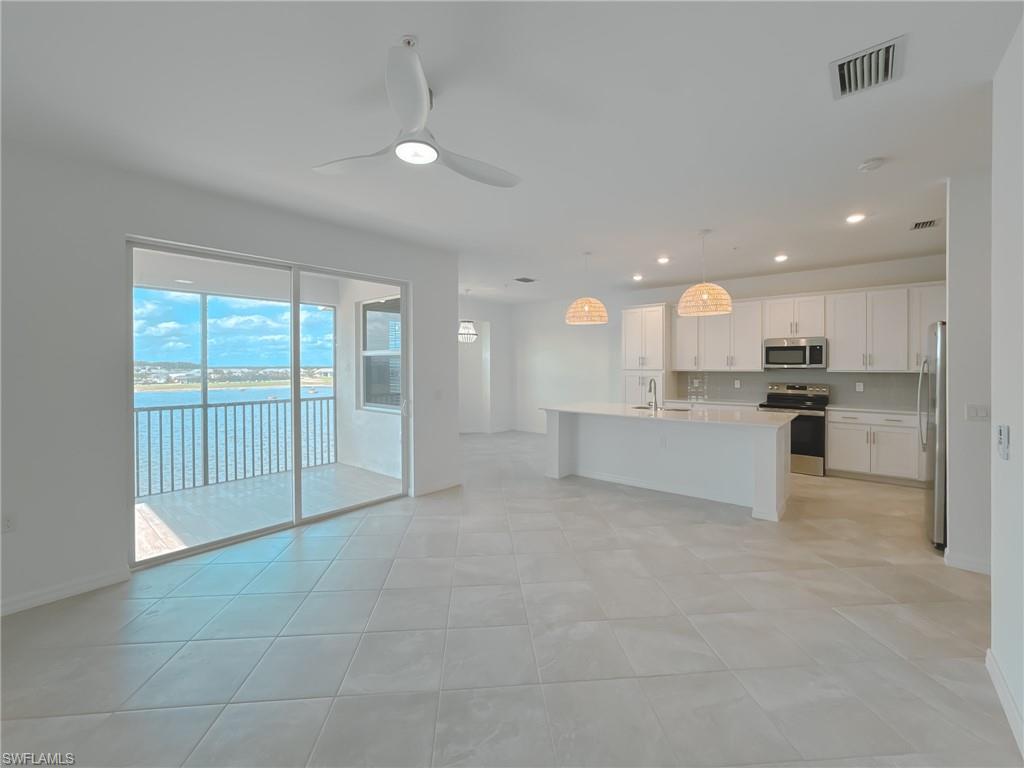 5583 Double Eagle Circle, Unit 4141 Ave Maria, FL 34142 - Photo 10 of 50 a view of a kitchen with a sink and cabinets