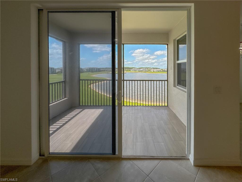 5583 Double Eagle Circle, Unit 4141 Ave Maria, FL 34142 - Photo 11 of 50 a view of porch with a floor to ceiling window and wooden floor