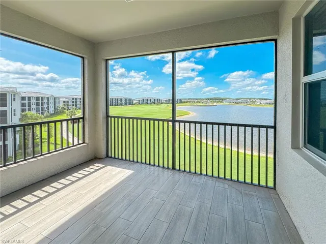 a view of porch with a floor to ceiling window and wooden floor